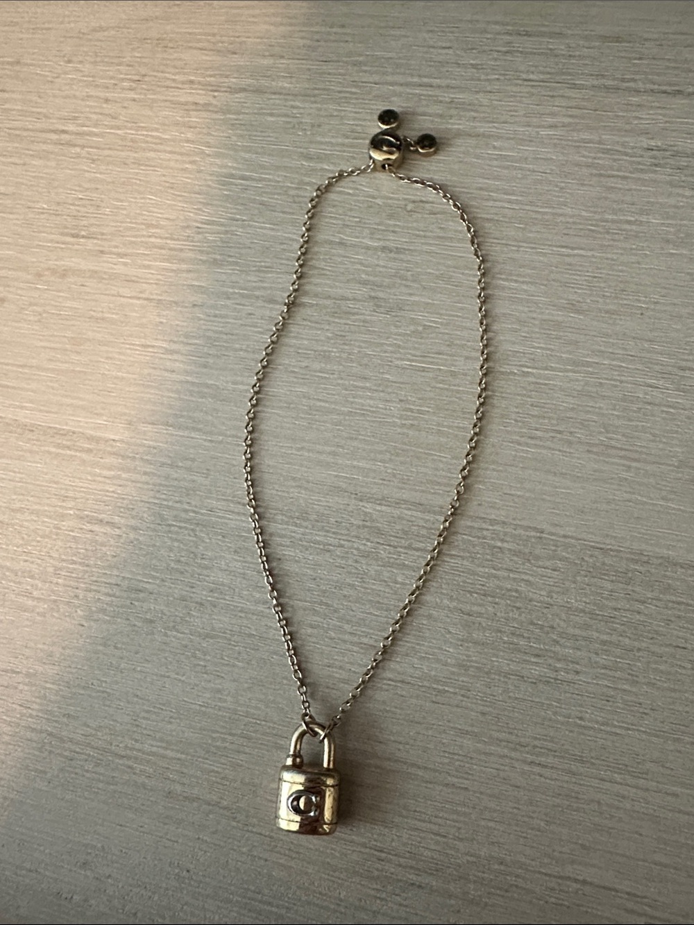 Coach gold padlock tennis bracelet